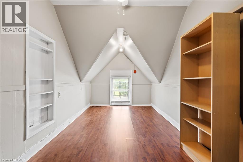 Bonus room with wood finished floors, built in features, vaulted ceiling, and a ceiling fan - 5368 Menzie Street, Niagara Falls, ON - Indoor Photo Showing Other Room