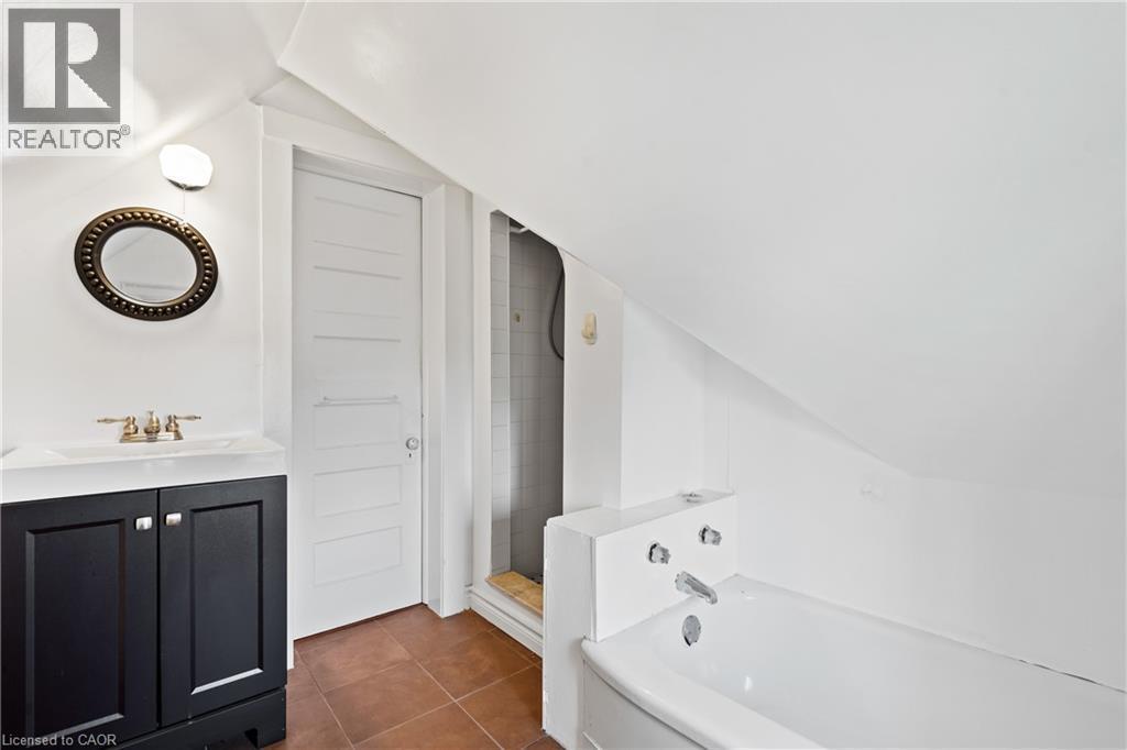 Full bathroom featuring vaulted ceiling, a bath, vanity, tile patterned flooring, and tiled shower - 5368 Menzie Street, Niagara Falls, ON - Indoor Photo Showing Bathroom