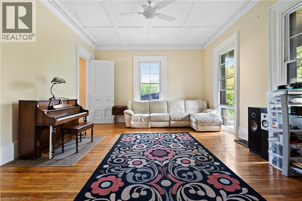 Living area with plenty of natural light, hardwood / wood-style floors, ceiling fan, and ornamental molding - 5368 Menzie Street, Niagara Falls, ON - Indoor