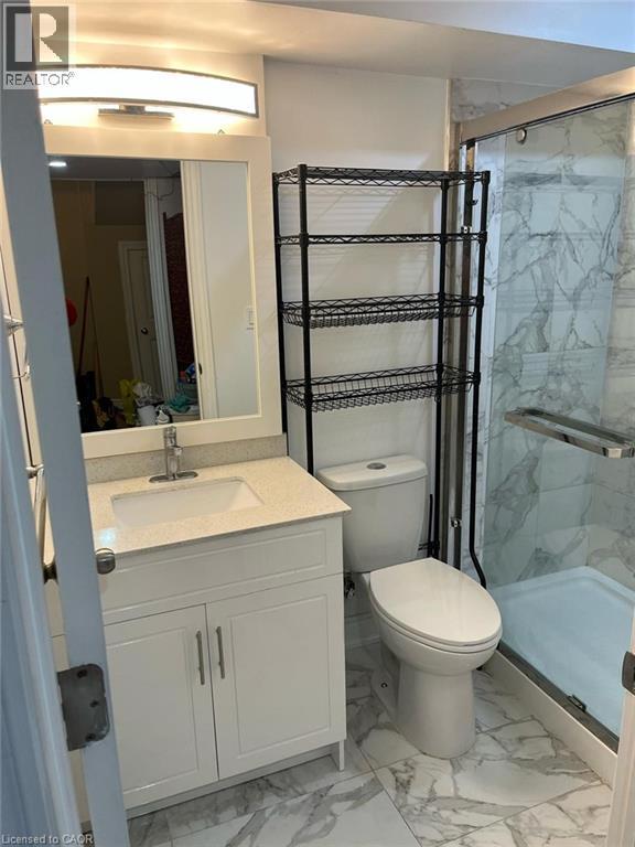 Full bath featuring light marble finish floors, vanity, and a marble finish shower - 110 Adler Drive, Cambridge, ON - Indoor Photo Showing Bathroom
