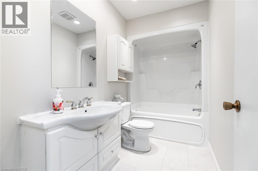 Bathroom with vanity, tile patterned floors, toilet, and shower / tub combination - 2340 King Street E, Hamilton, ON - Indoor Photo Showing Bathroom