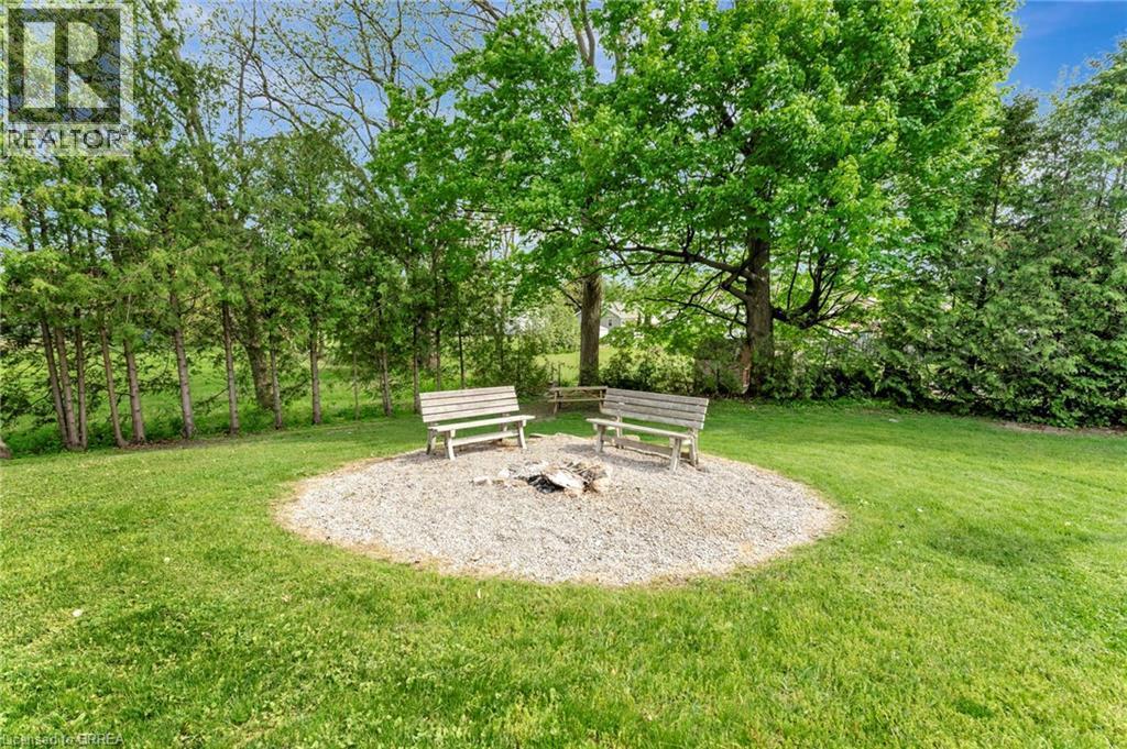 View of green lawn with view of wooded area - 1565 Old Brock Street, Vittoria, ON - Outdoor