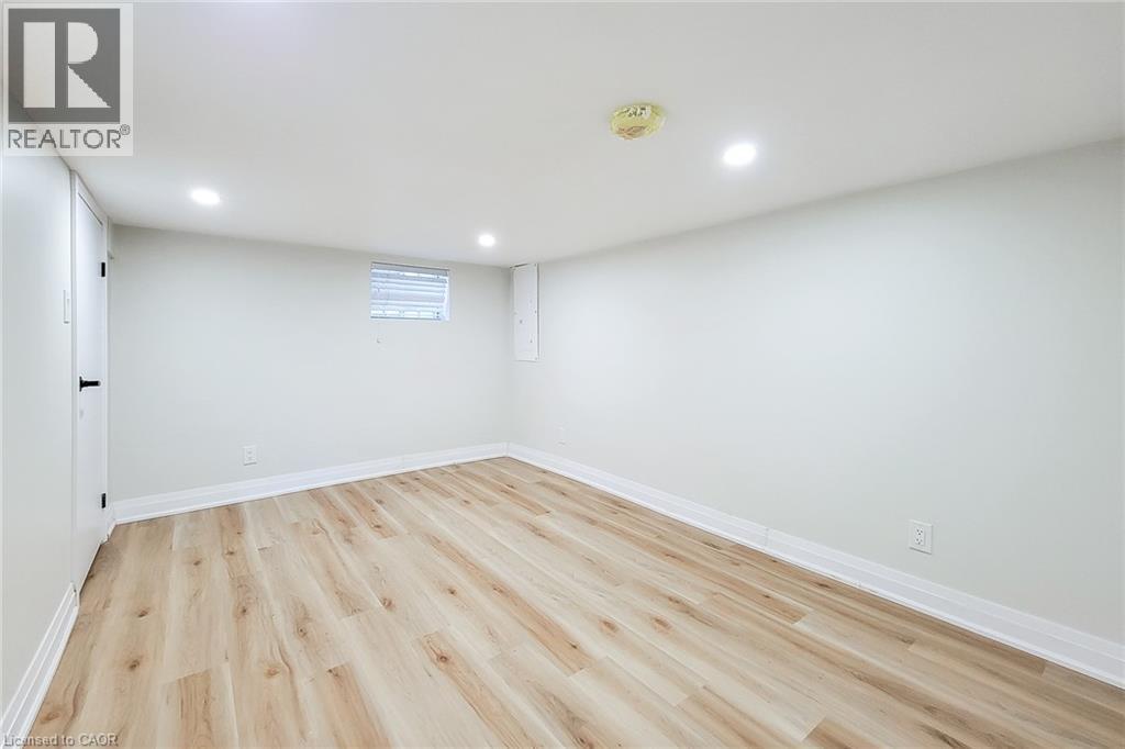 Below grade area with recessed lighting and light wood-style floors - 51 West Avenue N, Hamilton, ON - Indoor