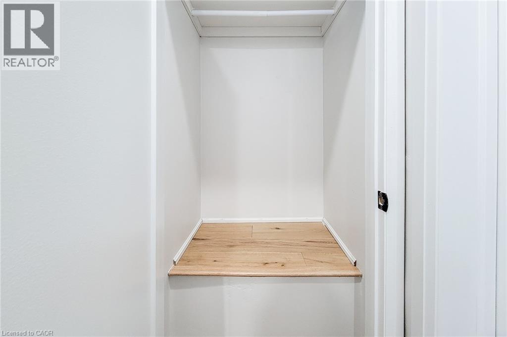 Walk in closet featuring light wood-style flooring - 51 West Avenue N, Hamilton, ON - Indoor Photo Showing Other Room