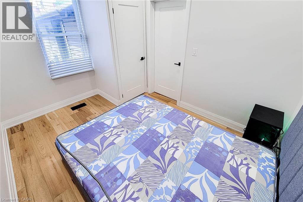 Bedroom with wood finished floors - 51 West Avenue N, Hamilton, ON - Indoor Photo Showing Bedroom