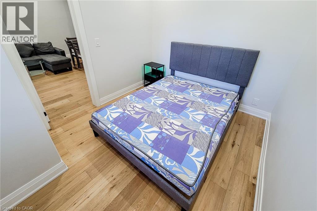 Bedroom featuring light wood-type flooring and baseboards - 51 West Avenue N, Hamilton, ON - Indoor Photo Showing Bedroom