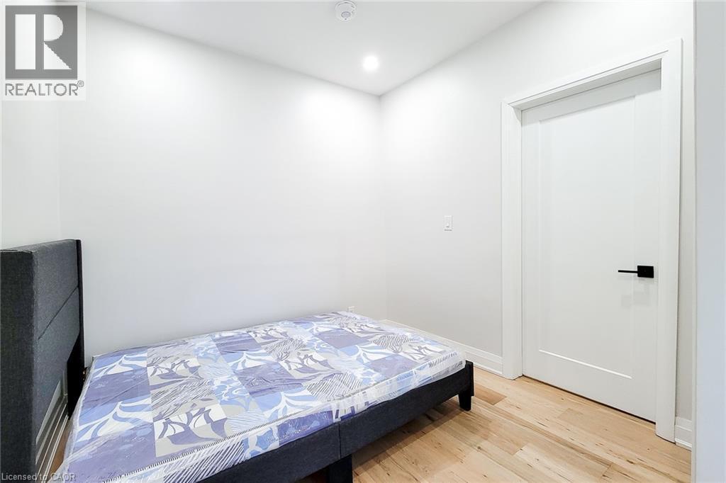 Bedroom with light wood finished floors and recessed lighting - 51 West Avenue N, Hamilton, ON - Indoor Photo Showing Bedroom