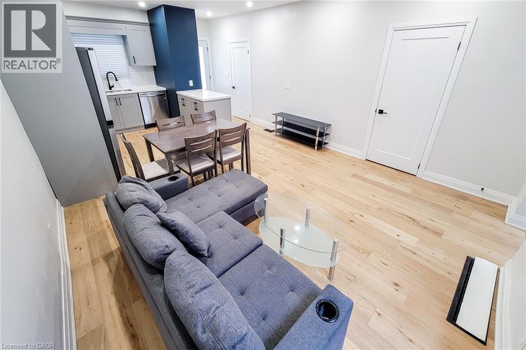 Living area featuring light wood-style flooring and recessed lighting - 51 West Avenue N, Hamilton, ON - Indoor Photo Showing Other Room