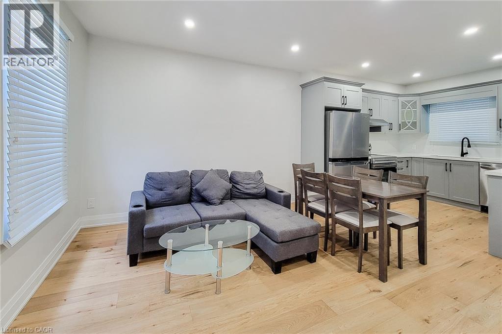 Living room with light wood finished floors and recessed lighting - 51 West Avenue N, Hamilton, ON - Indoor