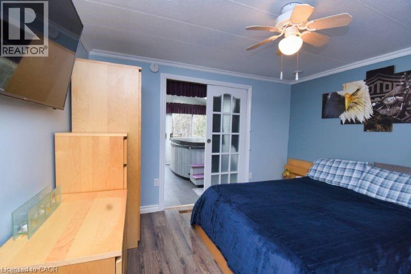 Bedroom with crown molding, dark wood-type flooring, and a ceiling fan - 1085 10Th Concession Road W Unit# 77, Flamborough, ON - Indoor Photo Showing Bedroom