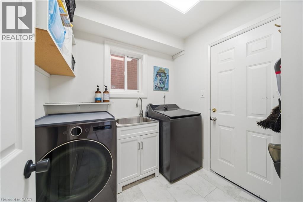 Laundry room with washer and dryer and a sink - 136 Braemar Avenue, Caledonia, ON - Indoor Photo Showing Laundry Room