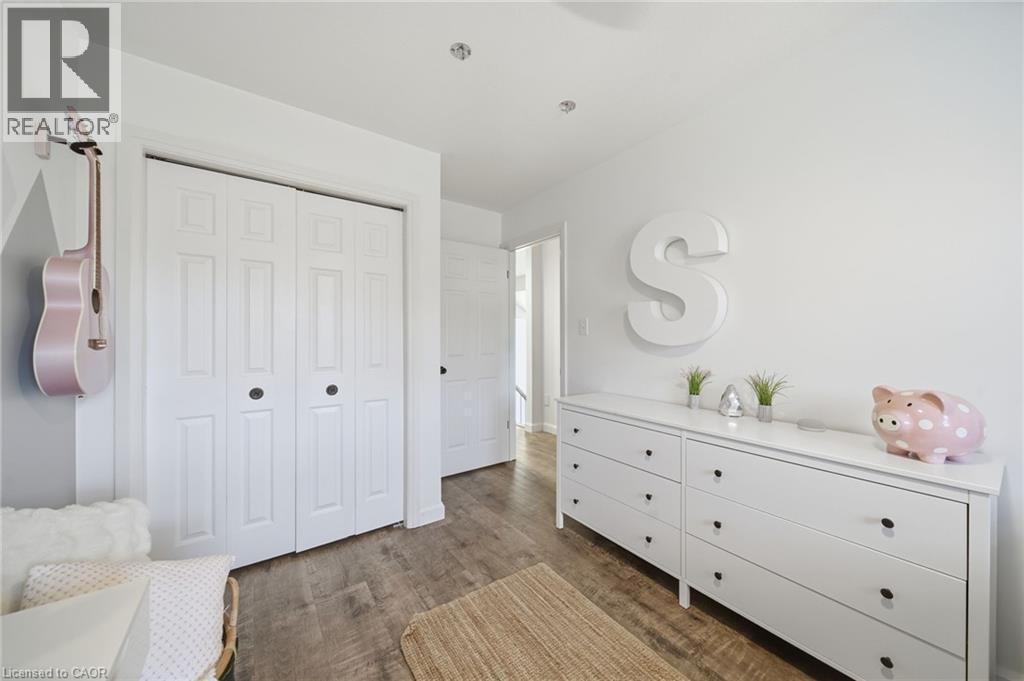 Bedroom featuring dark wood-style flooring and a closet - 136 Braemar Avenue, Caledonia, ON - Indoor Photo Showing Bedroom