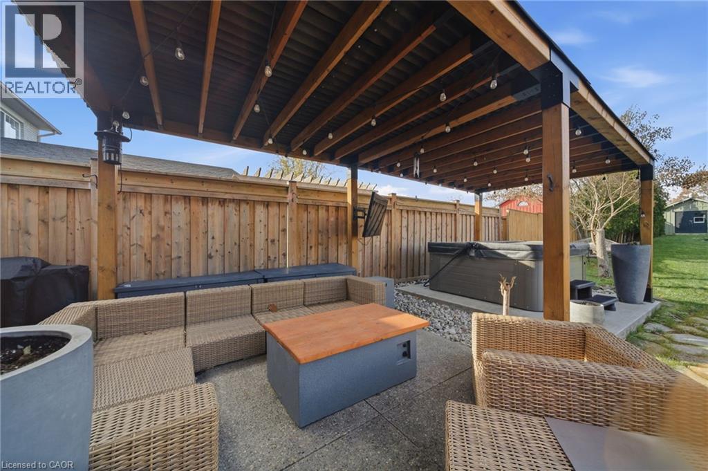 Fenced backyard featuring a hot tub, outdoor lounge area, a patio, and a grill - 136 Braemar Avenue, Caledonia, ON - Outdoor With Deck Patio Veranda With Exterior
