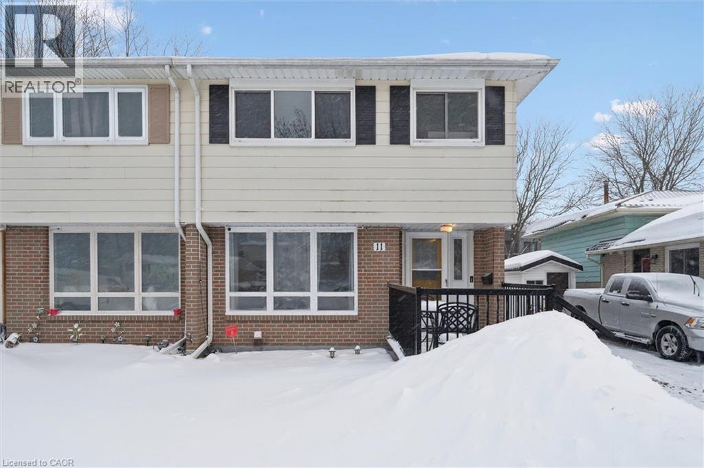 View of front of house featuring brick siding and a wooden deck - 11 Ingleside Drive, Kitchener, ON - Outdoor