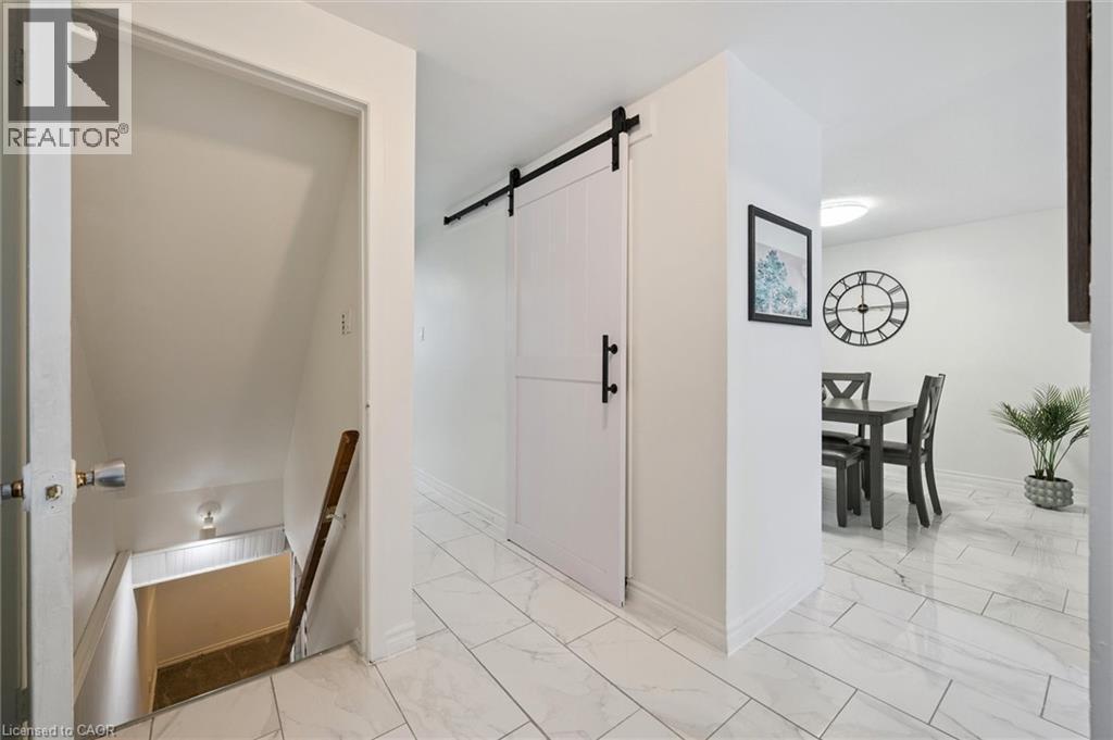 Corridor with an upstairs landing, a barn door, and light marble finish floors - 11 Ingleside Drive, Kitchener, ON - Indoor Photo Showing Other Room