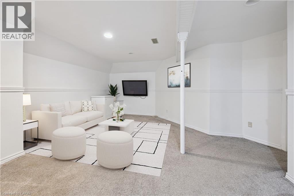Virtually staged family room featuring light carpet and recessed lighting - 11 Ingleside Drive, Kitchener, ON - Indoor Photo Showing Other Room