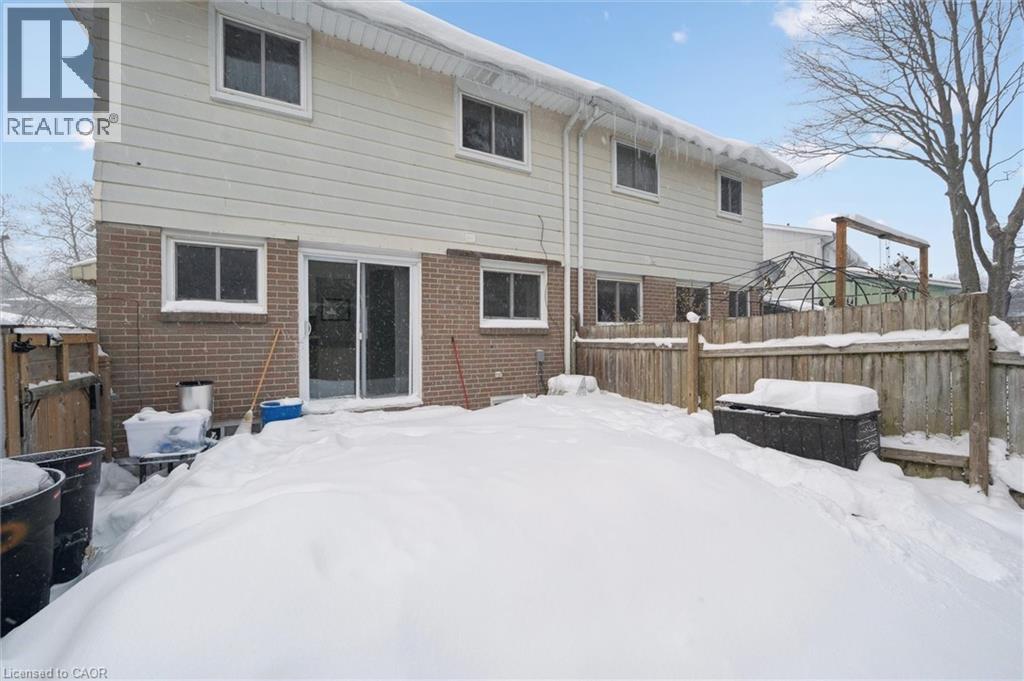 Snow covered rear of property with brick siding - 11 Ingleside Drive, Kitchener, ON - Outdoor With Exterior
