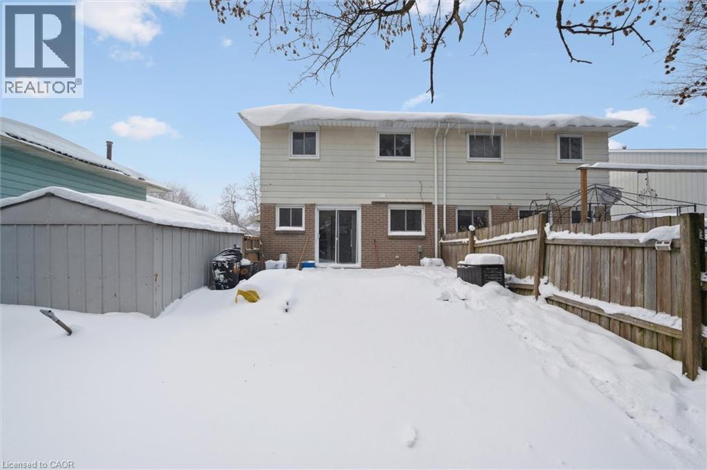 Snow covered rear of property featuring brick siding and a shed - 11 Ingleside Drive, Kitchener, ON - Outdoor