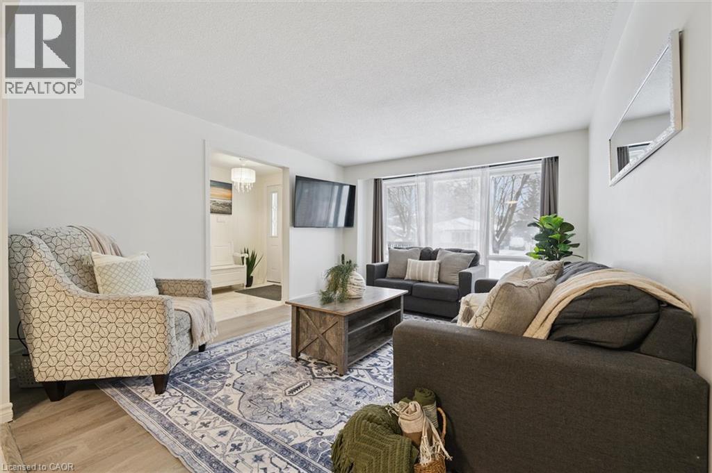Living room featuring wood finished floors and a textured ceiling - 11 Ingleside Drive, Kitchener, ON - Indoor Photo Showing Living Room