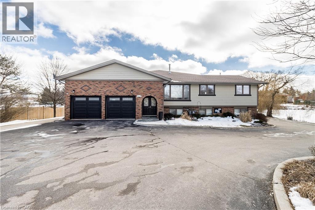 View of front of house featuring brick siding and asphalt driveway - 1615 Highland Road W, Kitchener, ON