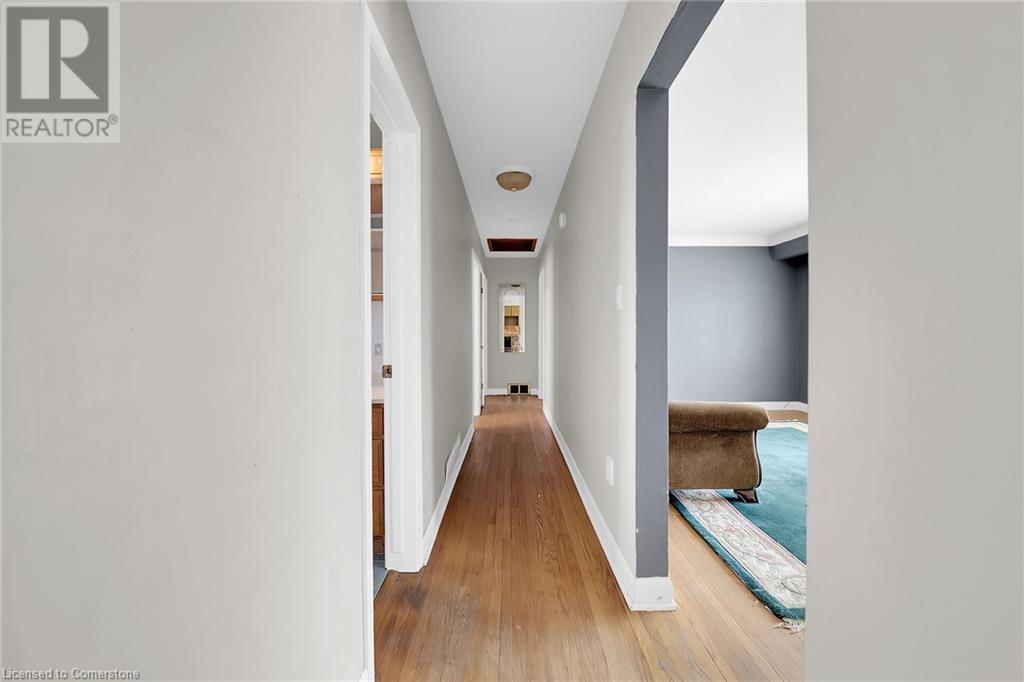 Hall with baseboards and wood finished floors - 9 Gavin Drive, St. Catharines, ON - Indoor Photo Showing Other Room