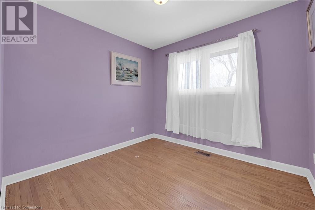 Unfurnished room with wood finished floors, baseboards, and visible vents - 9 Gavin Drive, St. Catharines, ON - Indoor Photo Showing Other Room