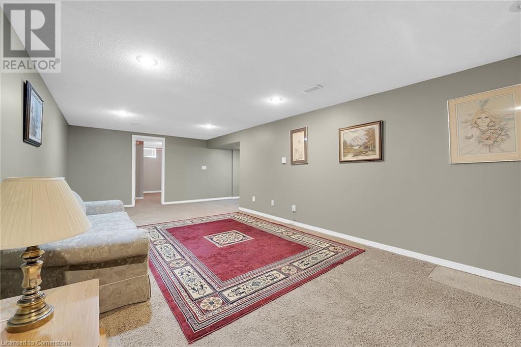 Living room featuring a textured ceiling, baseboards, carpet, and recessed lighting - 9 Gavin Drive, St. Catharines, ON - Indoor