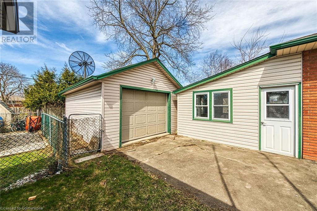 Detached garage with fence and concrete driveway - 9 Gavin Drive, St. Catharines, ON - Outdoor With Exterior
