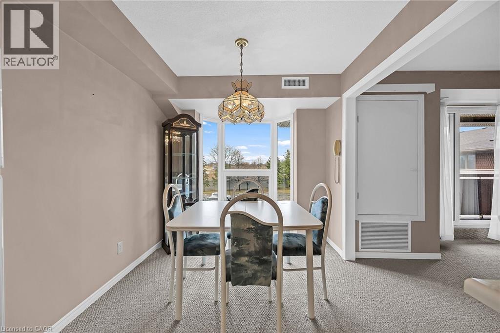 Carpeted dining room with baseboards, a chandelier, and visible vents - 416 Limeridge Road E Unit# 309, Hamilton, ON - Indoor