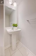Bathroom featuring light tile patterned floors and baseboards -