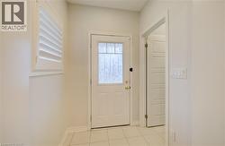 Entryway with tile patterned floors and baseboards -