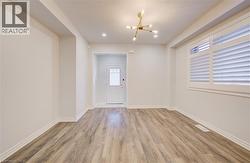 Entrance foyer with a chandelier, light wood-style floors, and recessed lighting -