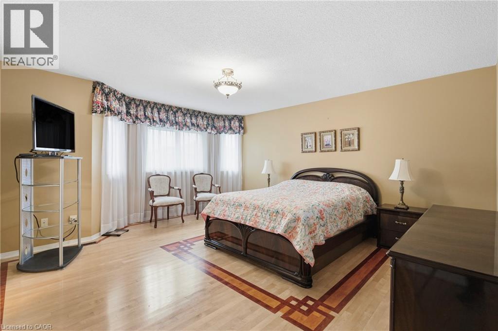 Bedroom featuring light wood-type flooring and a textured ceiling - 3372 Bobwhite Mews, Mississauga, ON