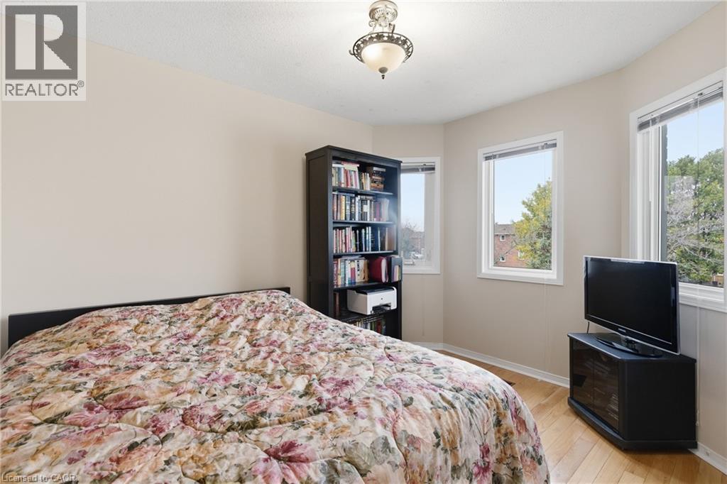 Bedroom with baseboards and light wood-style flooring - 3372 Bobwhite Mews, Mississauga, ON