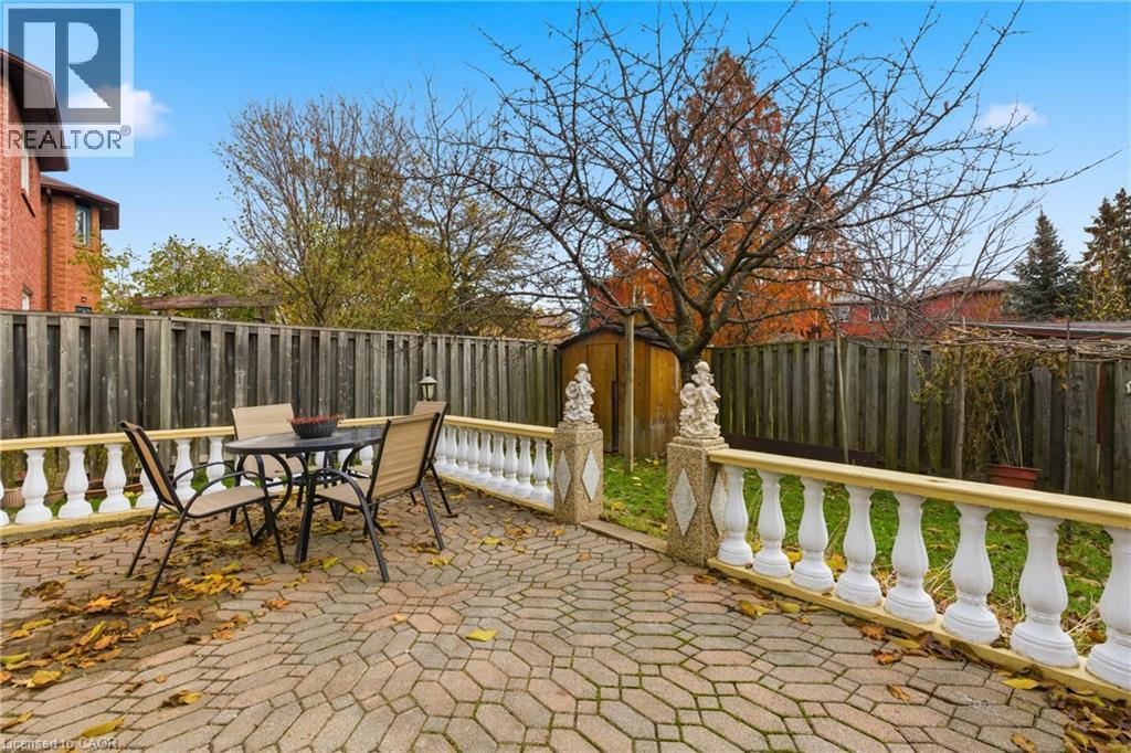 Fenced backyard featuring outdoor dining space and a patio area - 3372 Bobwhite Mews, Mississauga, ON