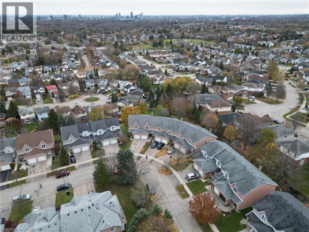 Aerial view of property and surrounding area with cityscape in the distance - 511 Oakvale Drive Unit# 1, Waterloo, ON - Outdoor With View