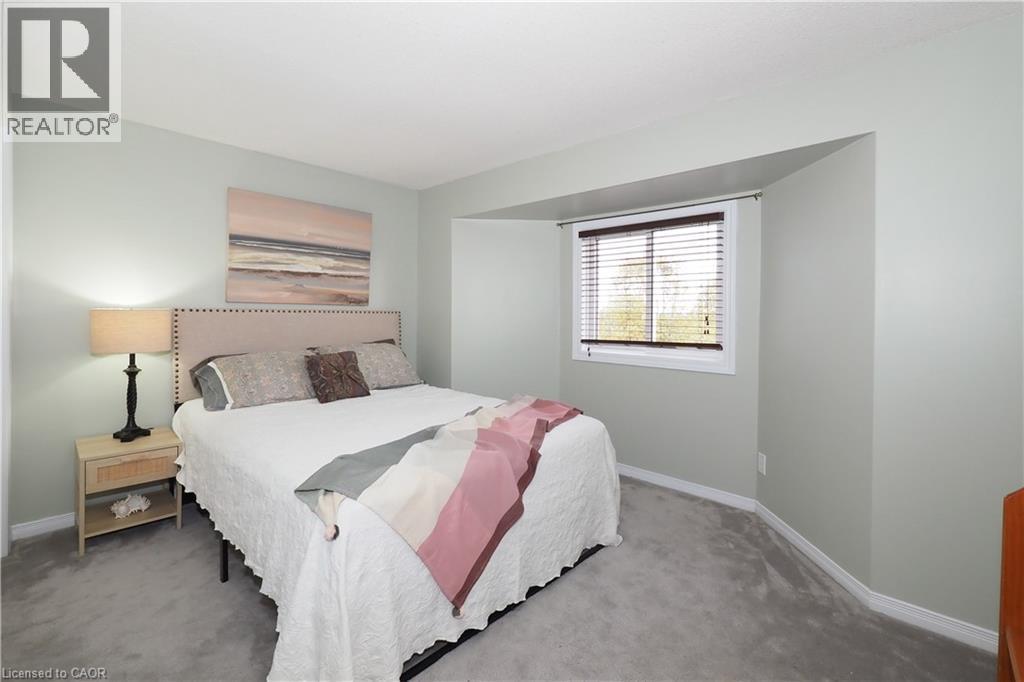Carpeted bedroom with large bump out window - 511 Oakvale Drive Unit# 1, Waterloo, ON - Indoor Photo Showing Bedroom