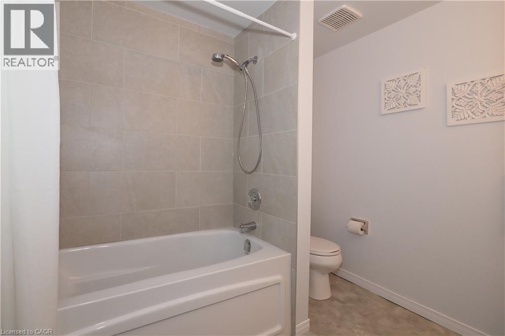 4-piece bathroom featuring brand new bathtub / shower combination with tiled walls - 511 Oakvale Drive Unit# 1, Waterloo, ON - Indoor Photo Showing Bathroom