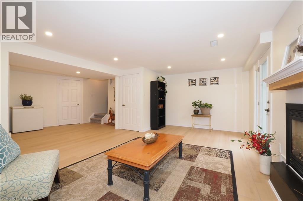 Recreation room with view of stairway going up to the main floor - 511 Oakvale Drive Unit# 1, Waterloo, ON - Indoor Photo Showing Living Room With Fireplace