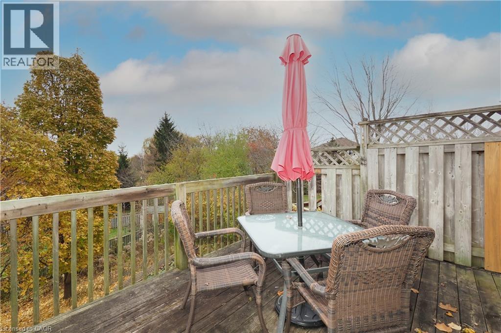 Wooden terrace with privacy fence with lattice featuring outdoor dining area - 511 Oakvale Drive Unit# 1, Waterloo, ON - Outdoor With Deck Patio Veranda