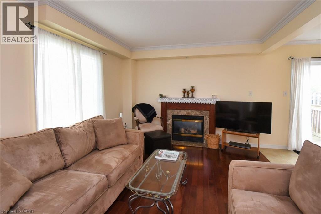 7 Southside Place Unit# 49, Hamilton, ON - Indoor Photo Showing Living Room With Fireplace