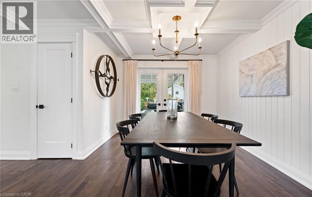 Dining area with french doors, a chandelier, beam ceiling, dark wood finished floors, and coffered ceiling - 735 George Street, Burlington, ON - Indoor Photo Showing Dining Room
