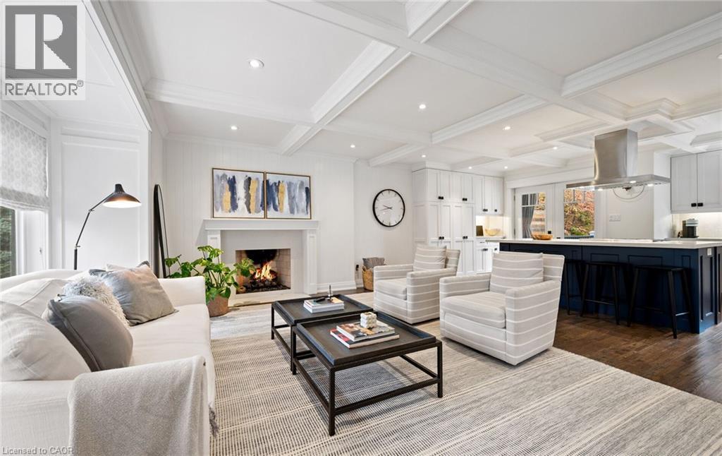 Living room featuring beamed ceiling, coffered ceiling, dark wood-style floors, a lit fireplace, and recessed lighting - 735 George Street, Burlington, ON - Indoor Photo Showing Living Room With Fireplace