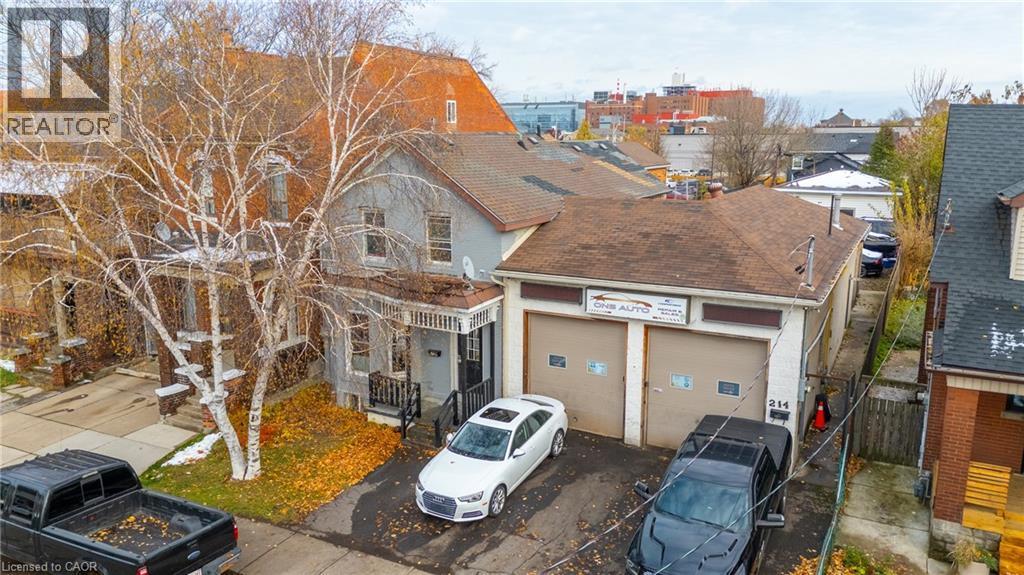 View of front of house with a garage, asphalt driveway, and roof with shingles - 246 Mary Street, Hamilton, ON
