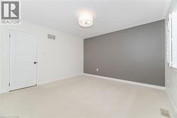 Unfurnished room featuring light carpet -
