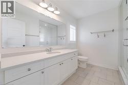 Full bath featuring vanity, light tile patterned floors, and a shower stall -