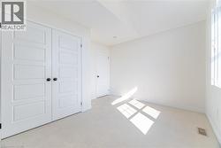 Unfurnished bedroom featuring light carpet and a closet -