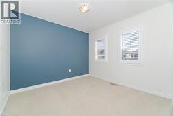 Empty room featuring carpet floors and baseboards -