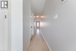 Corridor featuring light wood finished floors and baseboards -