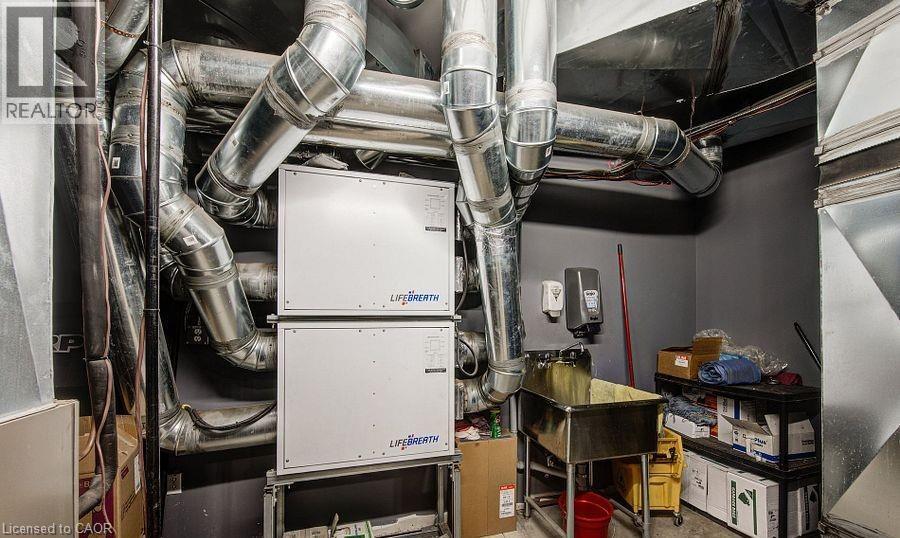 Utility room featuring heating unit and a sink - 55 Progress Drive E, Aylmer, ON